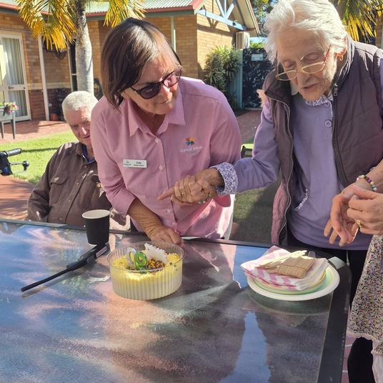 Resident receiving personalised care by staff