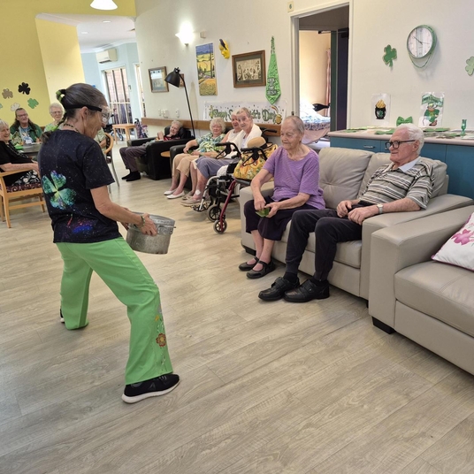 Resident and staff member cooking together