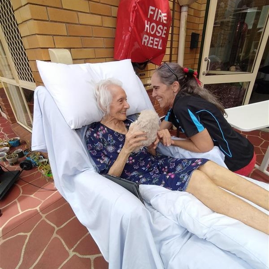 Resident and staff member cooking together