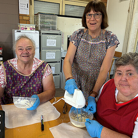 Residents cooking with staff member during activity