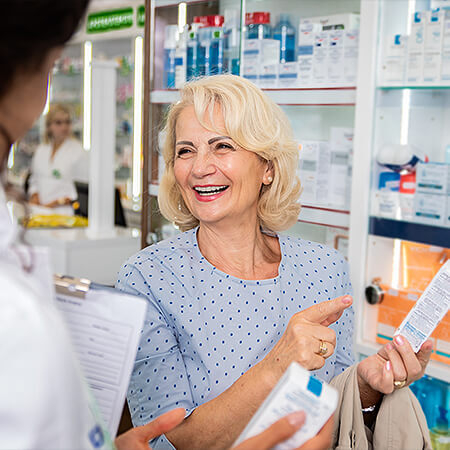Pharmacist speaks with customer about products available
