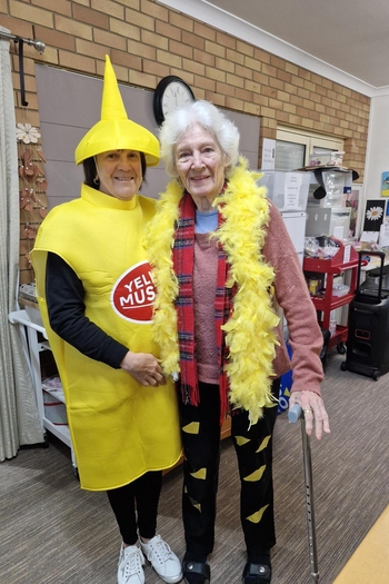 Carer and resident dress up for fun